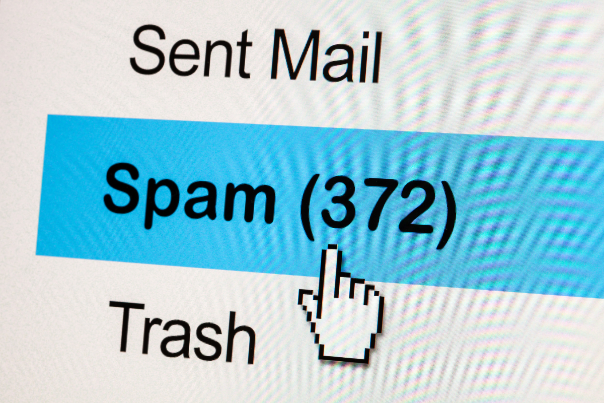 A cursor is pointing at the spam folder on a computer screen.