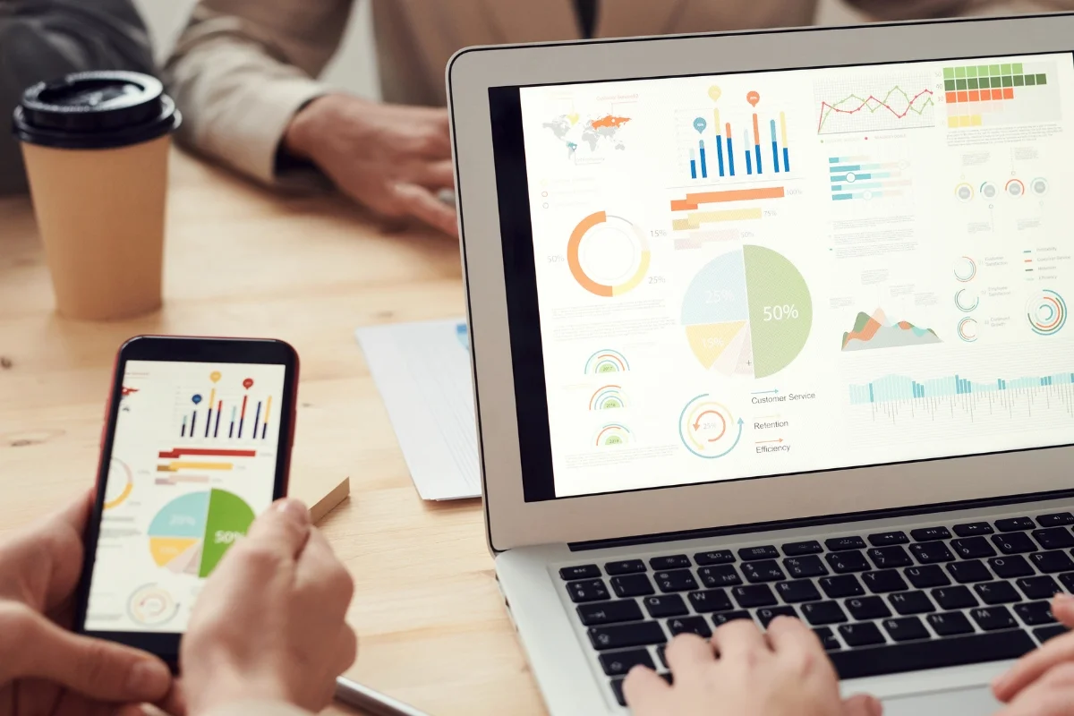 A group of people using a laptop, analyzing graphs on the Google Search Console.