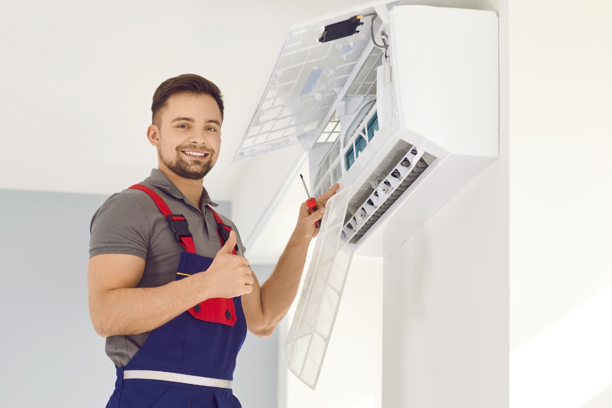 A man holding an HVAC unit and giving thumbs up for a Facebook advertising campaign.