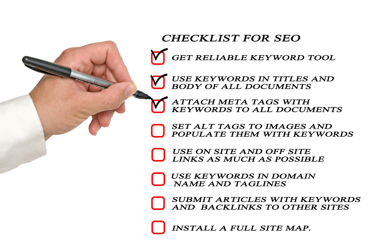 A hand checking an on-page SEO checklist.