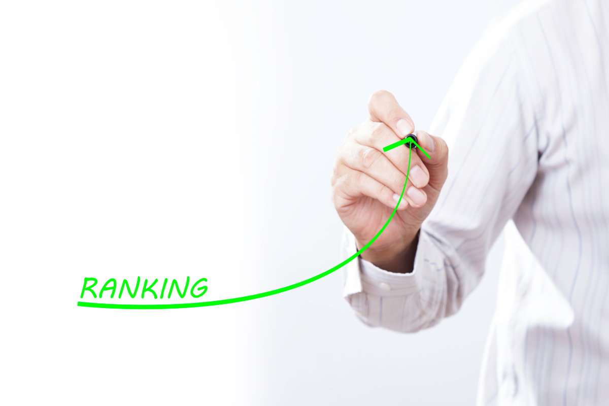 A hand drawing a green line with the word "ranking."