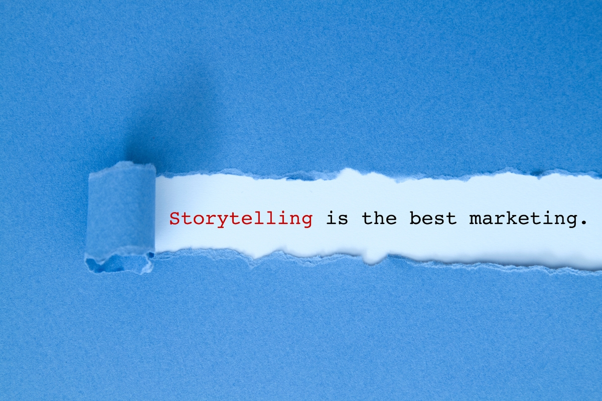 Torn blue paper revealing the message "storytelling is the best small business marketing strategy.