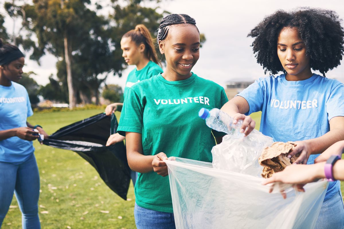 Group of volunteers engaging in sustainable marketing by cleaning up a park.