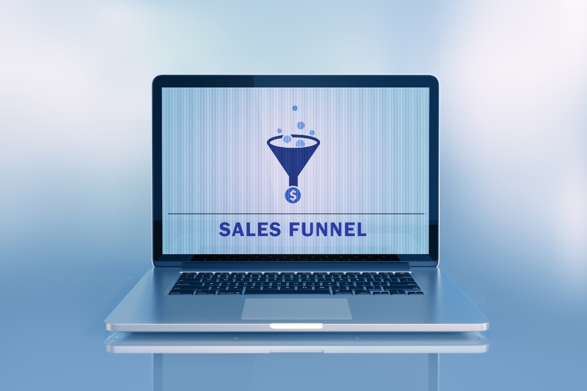 A laptop screen displaying the words "What is a sales funnel?