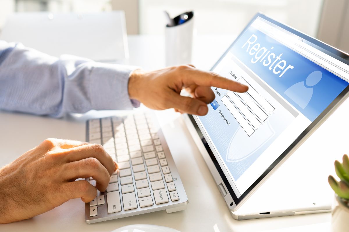 Man using a tablet to fill out a form online, having problems with elementor form not sending emails.