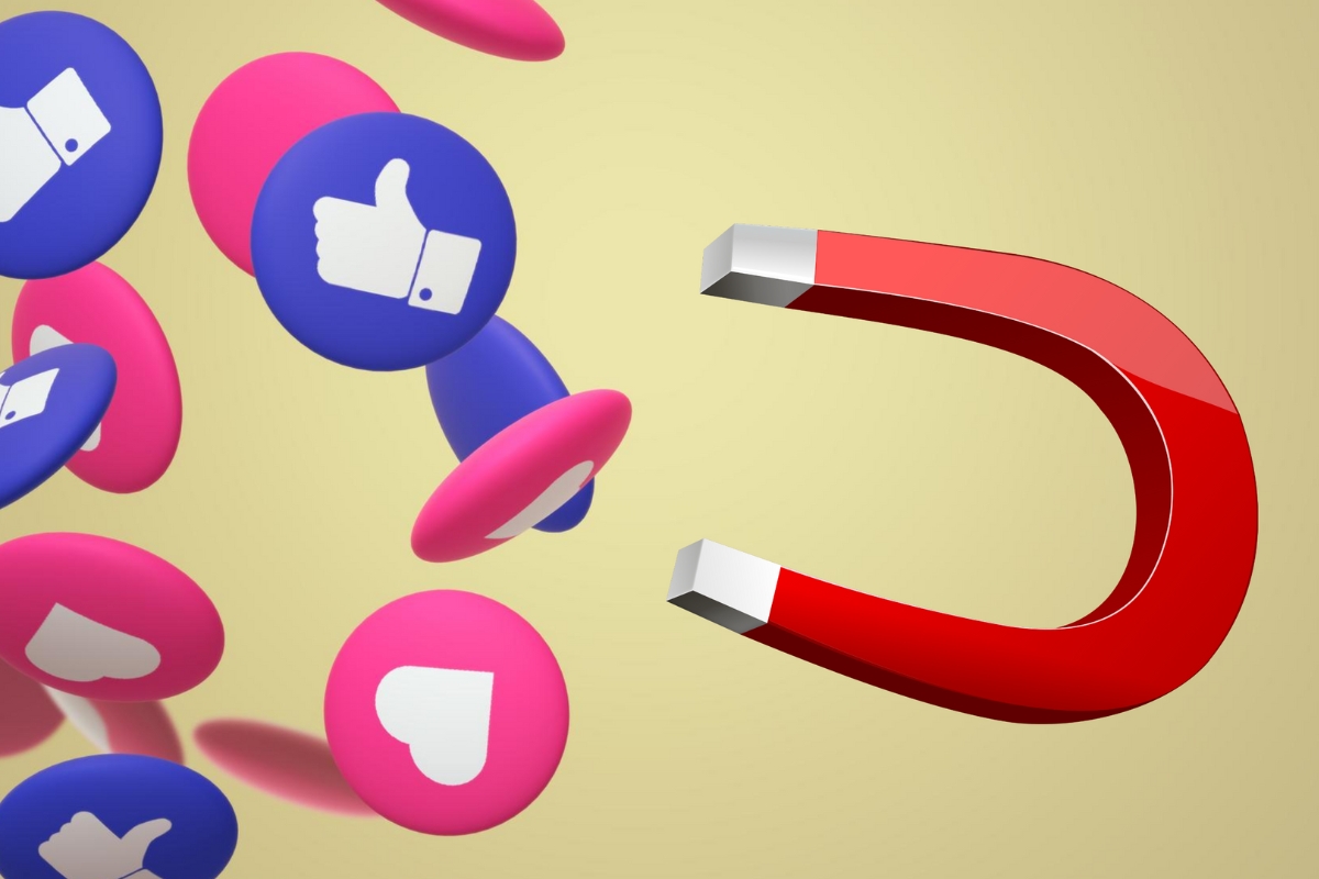 A large red horseshoe magnet attracting blue and pink Facebook icons with thumbs up and thumbs down symbols on a yellow background.