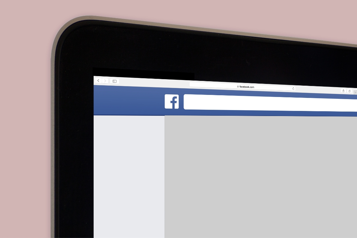 Close-up of a computer monitor displaying Facebook's homepage on the browser, with a pink background highlighting a Facebook marketing mistake.