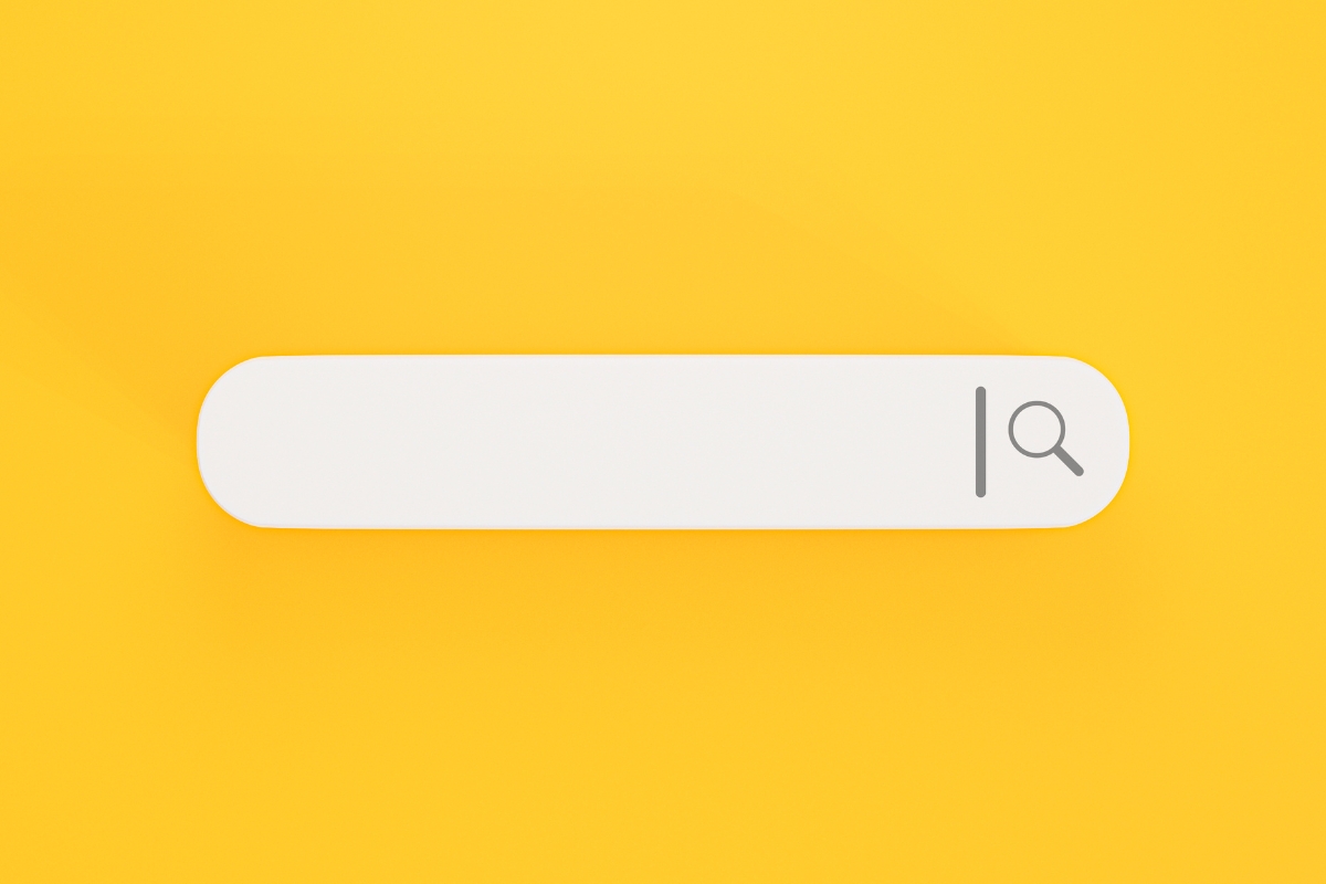 A minimalistic "how to search on a website" bar with a magnifying glass icon, centered on a vibrant yellow background.