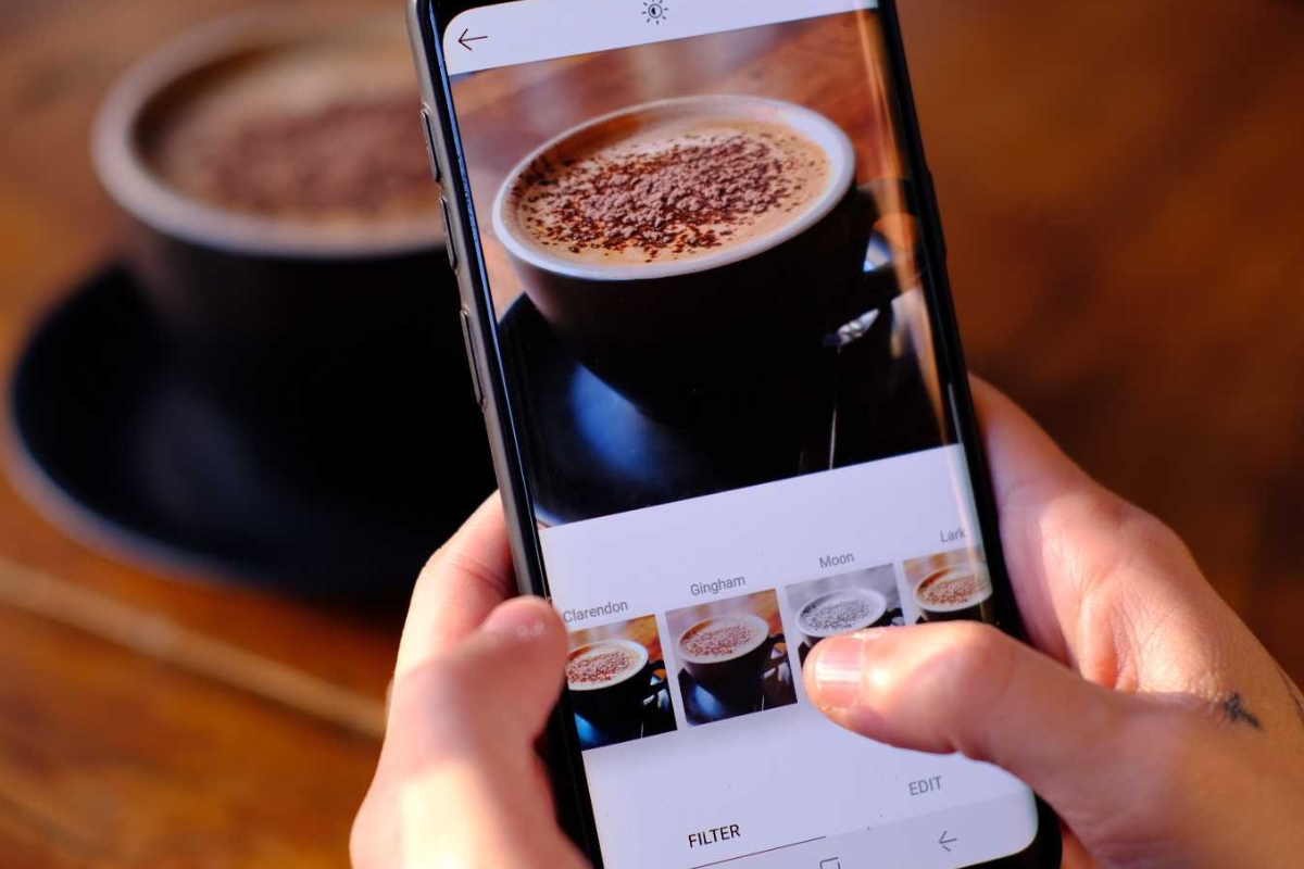 A person's hand holding a smartphone displaying the Instagram login screen, focusing on the username and password fields for Instagram marketing tips.