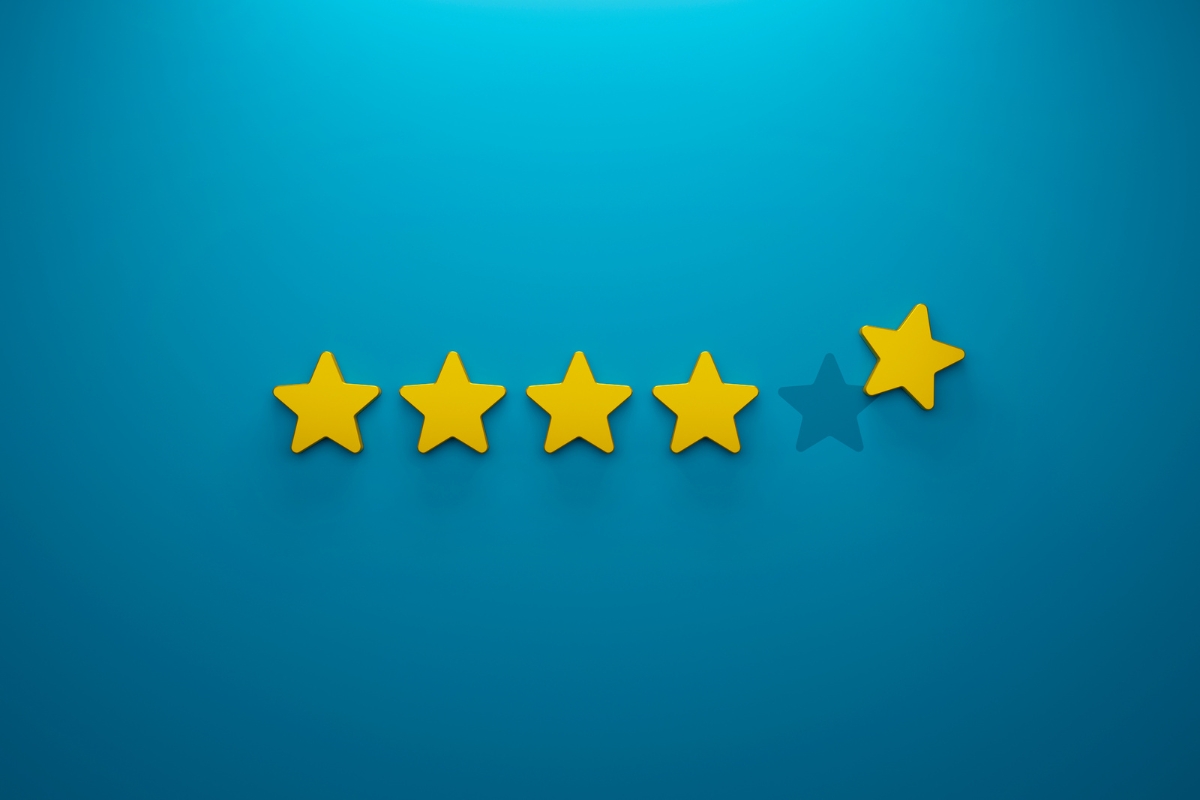 Five yellow stars in a row on a blue background, symbolizing a positive online reputation, with the last star slightly faded, implying a four-and-a-half star rating.