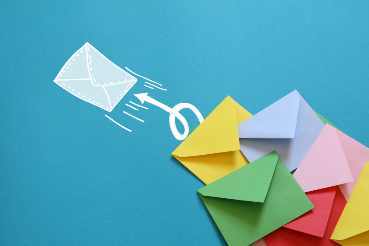 Colorful paper envelopes with a white arrow and envelope illustration on a blue background, reminiscent of email targeting.