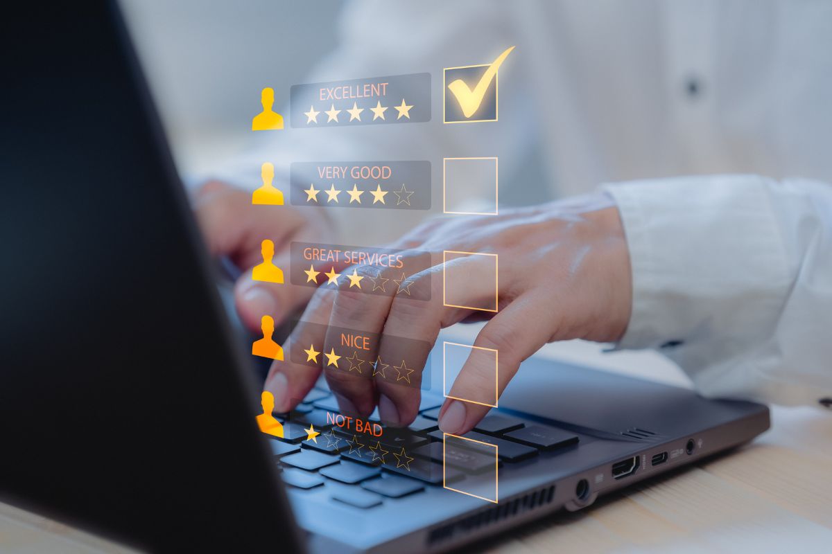 Hands typing on a laptop keyboard with a holographic overlay showing a five-tier customer feedback rating system, with the highest tier "Excellent" being selected, alongside engaging video testimonials popping up on the screen.