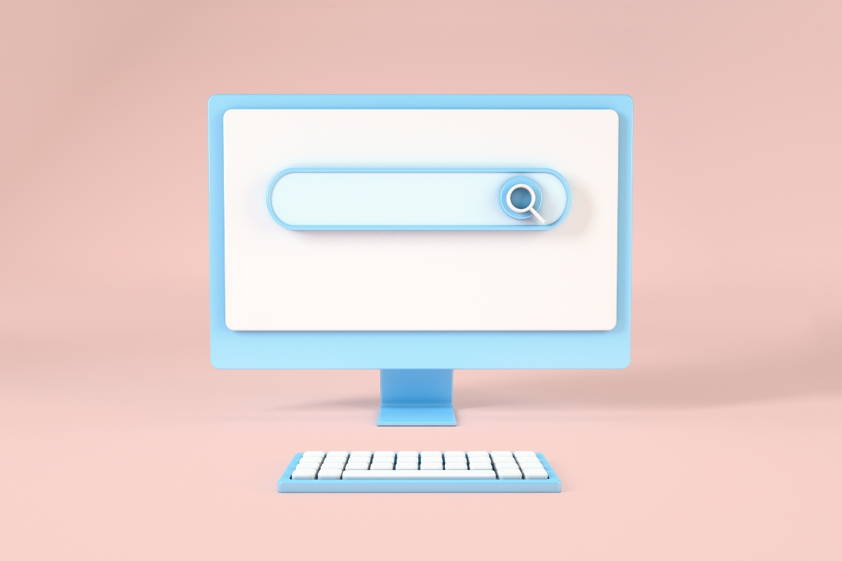 A blue computer monitor with a white screen showing a search bar and magnifying glass icon similar to what you’d find on Ecosia search engine. A matching blue and white keyboard is in front of the monitor. The background is light pink.