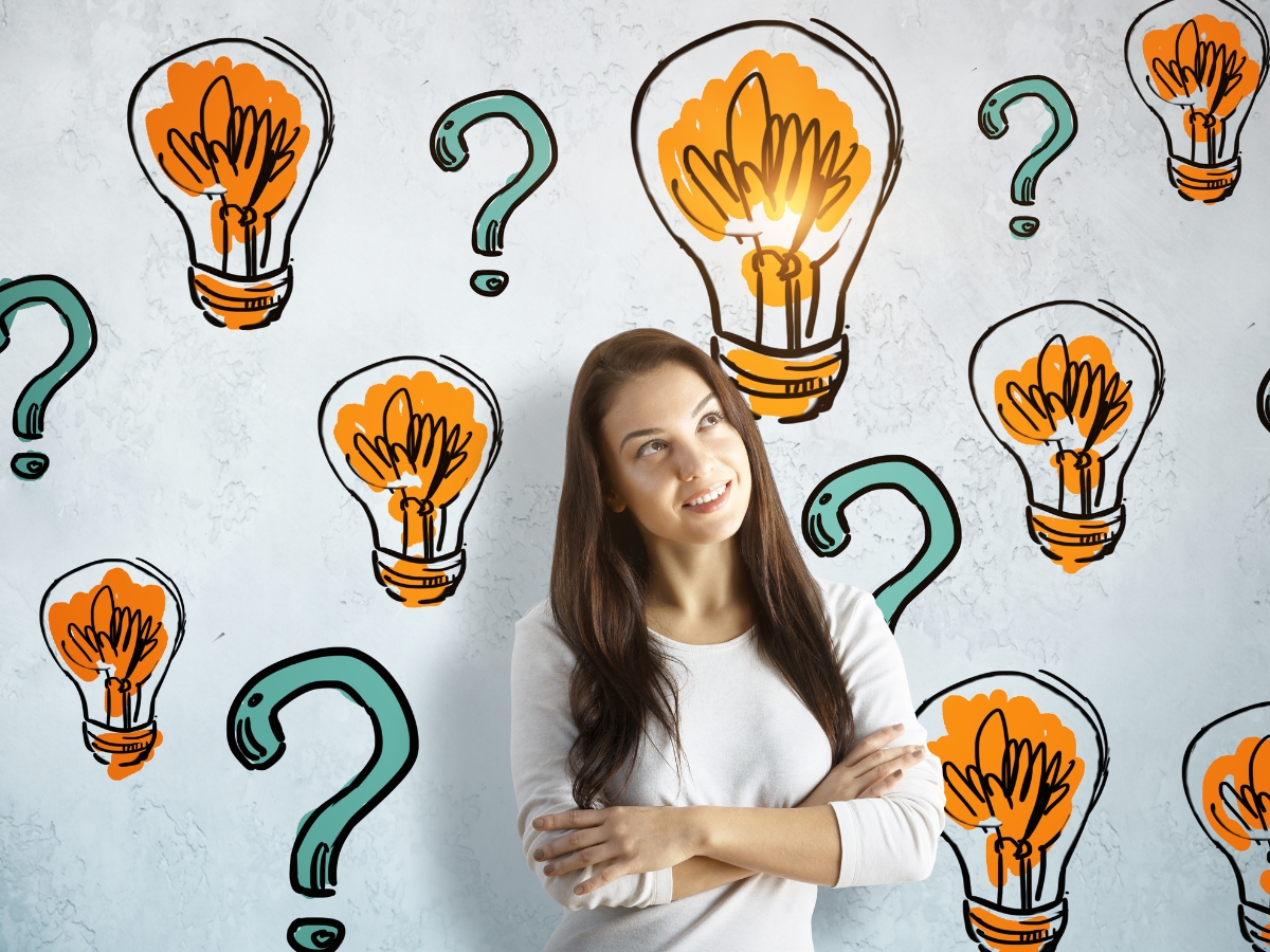 a woman standing in front of a wall with light bulbs drawn on it