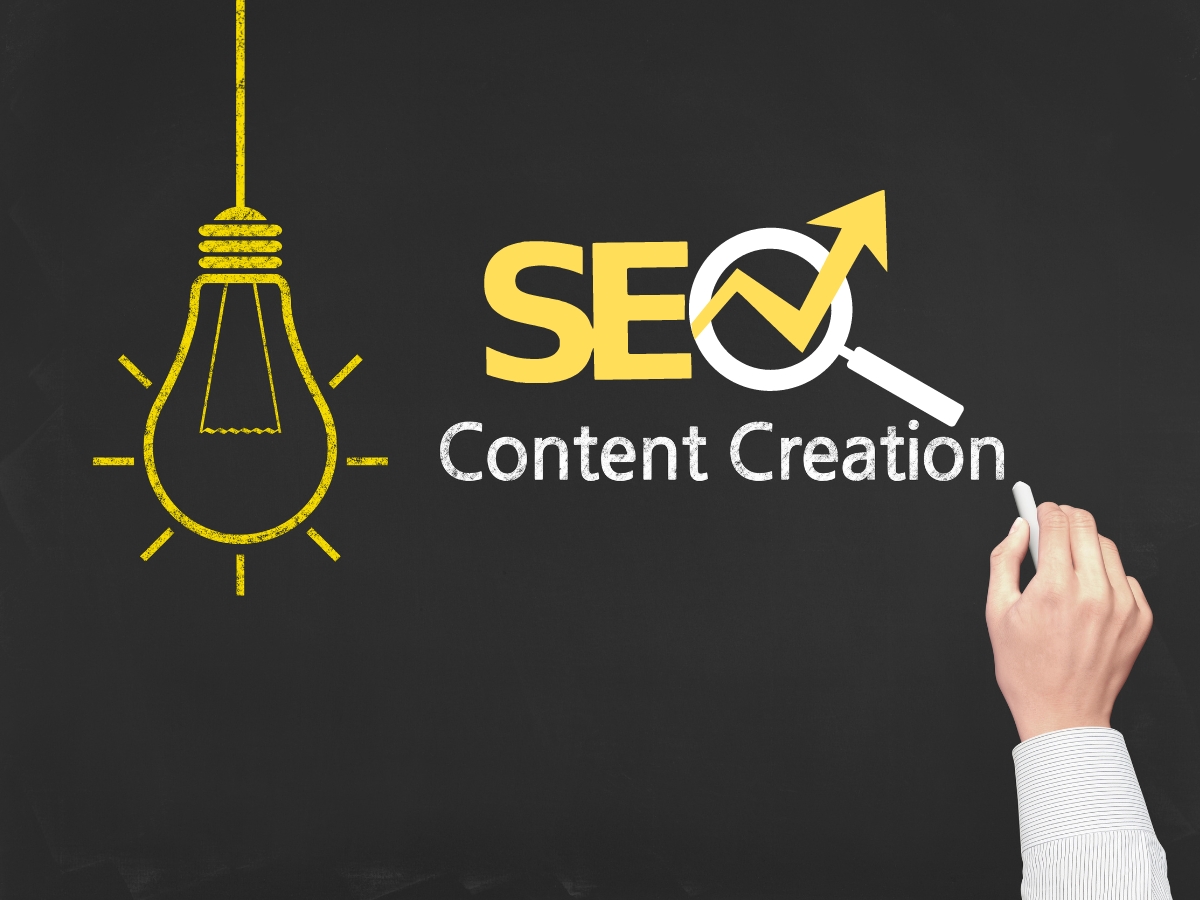 A hand writing on a blackboard displays a yellow lightbulb and the phrase "SEO Content Creation," with the "O" cleverly represented by a magnifying glass.