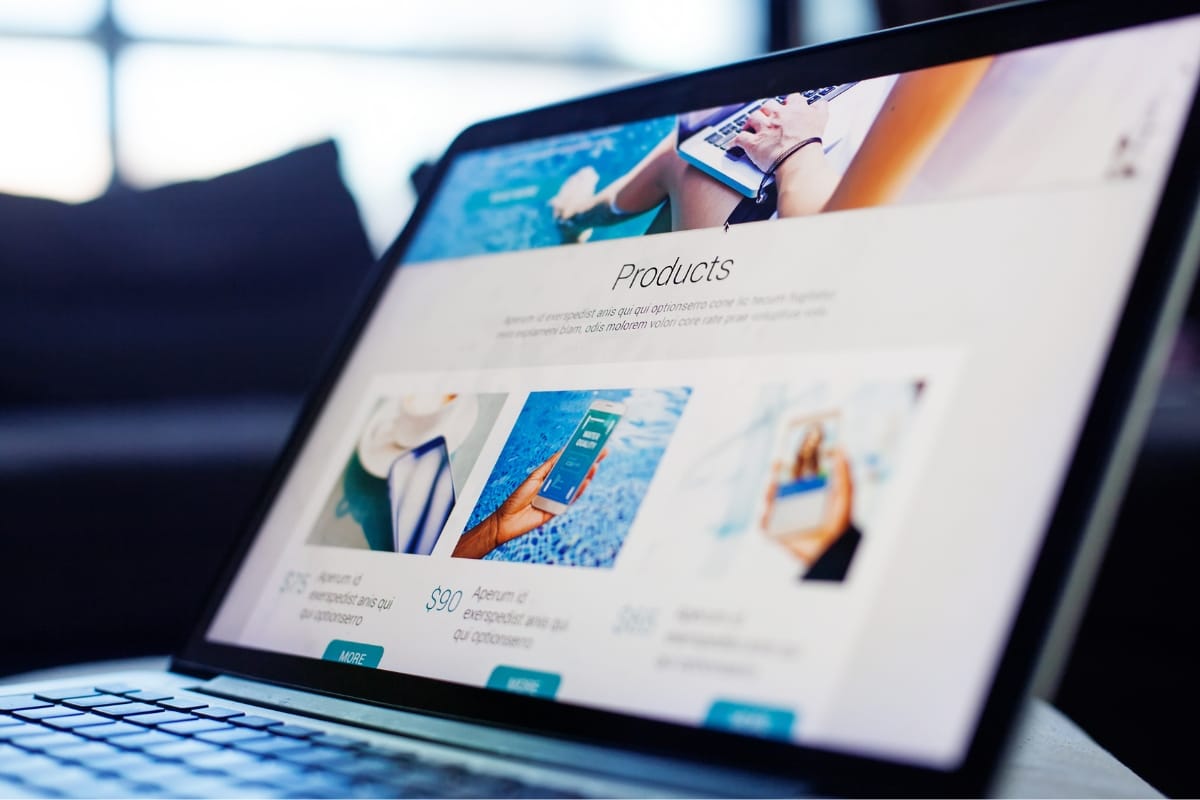 A laptop screen showcases a website built with WordPress, featuring an optimized "Products" section that enhances loading speed by efficiently managing the database. Images and descriptions are seamlessly displayed, offering a smooth browsing experience.